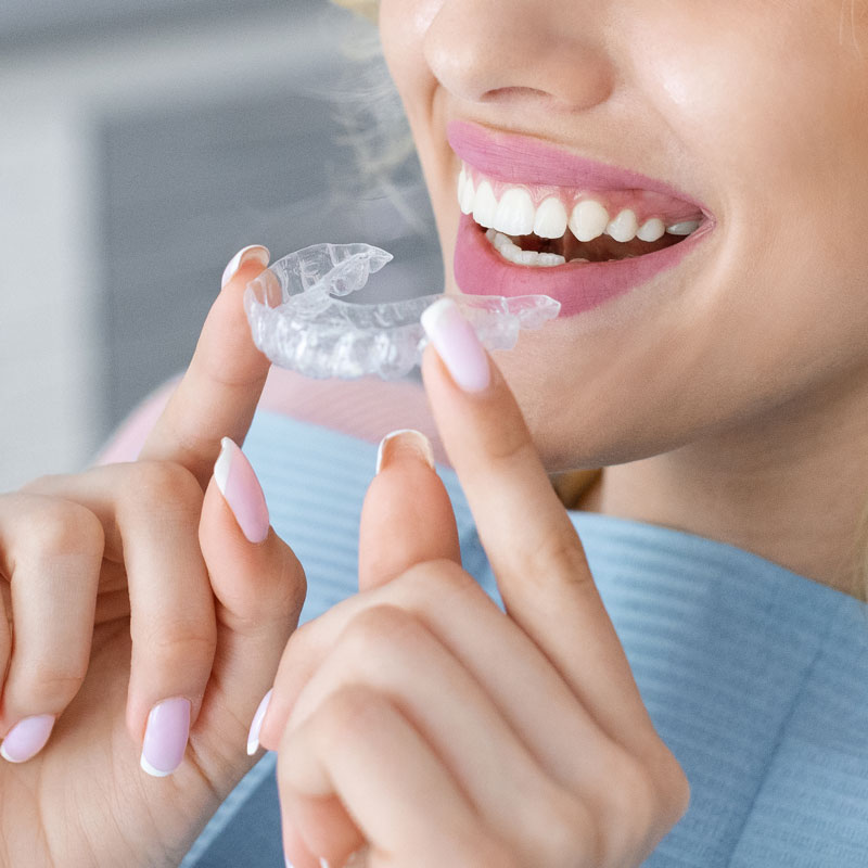 woman inserting clear aligners
